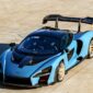McCollisters A blue McLaren Senna sports car with a large rear wing is parked on a sunlit concrete surface, viewed from above—an ideal candidate for car shipping that emphasizes flexibility in auto transport solutions.
